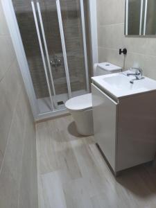 a bathroom with a shower and a toilet and a sink at Hostal el Olivo in Mora