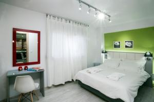 a bedroom with a bed and a desk and a mirror at Villa NK in Paleo Tsifliki