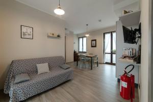 a living room with a couch and a table at Casa Rubbo - Appartamento in collina 'Monviso' in Alba