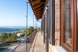 a balcony with a view of a car on a hill at Casa Rubbo - Appartamento in collina 'Monviso' in Alba