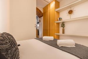 a bedroom with a bed with two pillows on it at Condessa Heaven RC in Lisbon