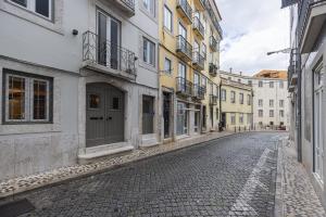 an empty street in an old town with buildings at Condessa Heaven RC in Lisbon