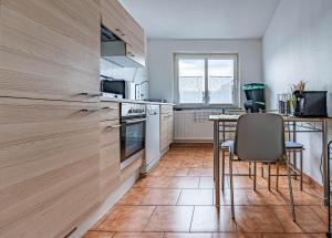 a kitchen with a table and chairs in a room at Pension Bärbel Neelen in Hameln