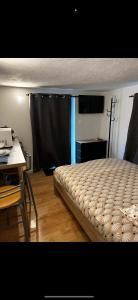 a bedroom with a bed and a table and a desk at Beau studio dans le centre de Bourges historique ! in Bourges