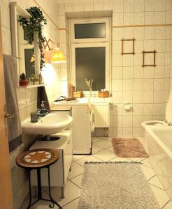 Baño blanco con lavabo y bañera en Spacious Home in Old-West - Leutsch, en Leipzig
