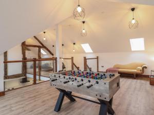 a ping pong table in the middle of a room at Y Côr in Corwen