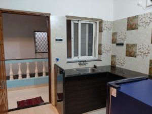 a kitchen with a sink and a window at Cyprian Holiday Homes in Calangute