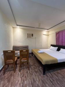 Ένα ή περισσότερα κρεβάτια σε δωμάτιο στο Mumbai Residency