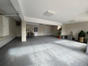 a large empty room with a table and chairs at Paws & Relax Retreat in Kalabaka