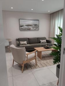 a living room with a couch and a coffee table at 222 Terrace Sandton Gate Luxury Apartment in Johannesburg
