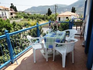 a table and chairs on a balcony with a view at Smile Stella Studios in Skopelos Town