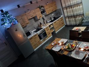 a kitchen with a table with a plate of food on it at Apartament exclusive Głuszyca in Głuszyca