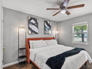 a bedroom with a bed and a ceiling fan at Casa Noa in Euless