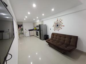 a living room with a couch and a kitchen at Apto Marbella in Cartagena de Indias