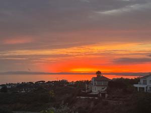 a sunset over the ocean with a house at Marbella Boutique Art suites in Marbella