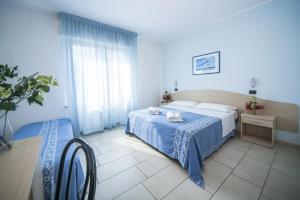Postel nebo postele na pokoji v ubytování Hotel Lorenzo