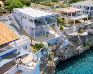 an aerial view of a house on the water at Blue Lagun Apartment B in Willemstad