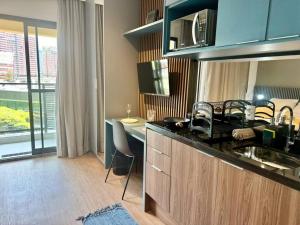 a kitchen with a sink and a table in a room at 512 - Rentaqui Studio no Brooklin Sofisticação in Sao Paulo +4 photos