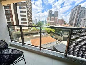 a balcony with a view of a city skyline at 512 - Rentaqui Studio no Brooklin Sofisticação in Sao Paulo
