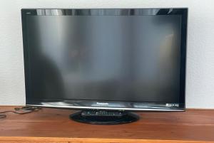 a flat screen tv sitting on top of a wooden table at Just Pension & Bar in Gadebusch +49 photos