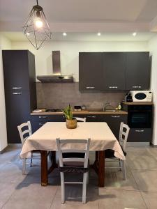 a kitchen with a table and chairs in a kitchen at Sant Agata House in Ravenna