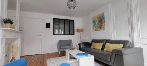 a living room with a couch and a chair at Belle époque in Granville