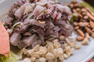 a white plate of food with pasta and beans at Hotel Relajate in Lobitos +15 photos