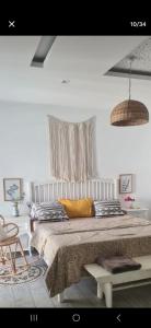 a bedroom with a large bed and two chairs at Cozy apartment 10 min from Airport in Tunis +3 photos