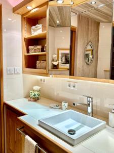 a bathroom with a sink and a mirror at Logis Saint-Flaceau in Le Mans +51 photos