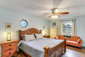 a bedroom with a bed and a ceiling fan at Walk to Sandusky Bay Home with Hot Tub and Fire Pit! in Sandusky