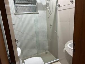 a bathroom with a shower with a toilet and a sink at Novíssimo apt 1 quarto Centro frente à Prefeitura in Nova Friburgo