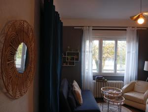 a living room with a mirror and a couch at Appartement 2 hyper centre Lorient in Lorient