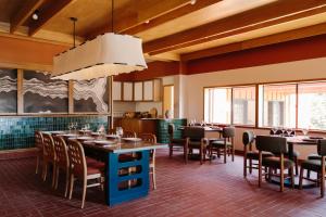 a dining room with tables and chairs and a chandelier at Lodge At Marconi in Marshall