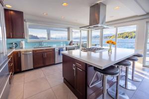 a kitchen with a large island with a counter top at Walls of Glass Hood Canal Vacation Rental in Union