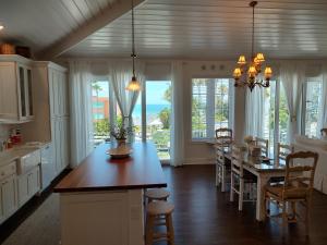 a kitchen with a table and chairs and a dining room at Bungalow Beach Resort in Bradenton Beach