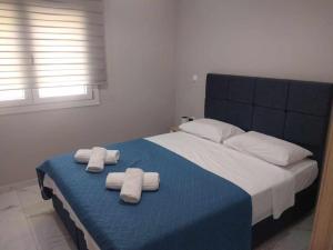 a bedroom with a bed with two towels on it at Chios Cozy Apartment 2 in Sklaviá