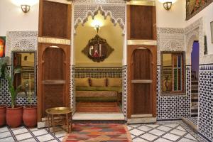 a lobby of a mosque with a couch and a mirror at Riad Rayhana-Exclusive Riad Experience in Fes Medina in Fès