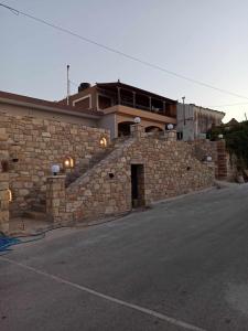 a brick building with a building on top of it at Chios Cozy Apartment 2 in Sklaviá
