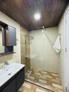 a bathroom with a shower and a sink at Black mamba in Gudauri