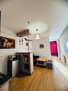 a large living room with a wooden floor and white walls at Black mamba in Gudauri