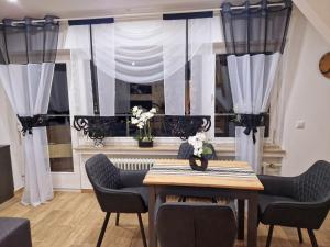 a dining room with a table and chairs and a window at VilaMi Ferienwohnung in Schonwald im Schwarzwald +22 photos