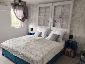 a bedroom with a bed with white sheets and pillows at Villa Evetes in Jablonov nad Turnou +79 photos