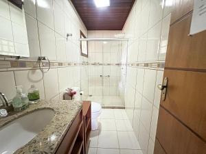 a bathroom with a tub and a toilet and a sink at Refúgio Maravilhoso na barra do Sana | SAAP376 in Sana +143 photos