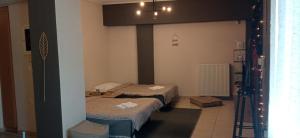 a room with three beds in a room with lights at La casa bella di Chalkida in Chalkida