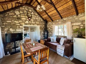 a living room with a table and a couch at Echo Valley Guest Farm in Breyten