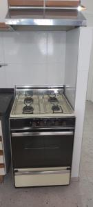 a stove top oven sitting in a kitchen at Casa EL HORNERO 2 con cochera en gran Mendoza in Godoy Cruz +10 photos