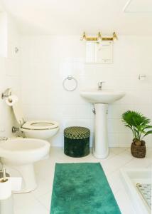 ein weißes Badezimmer mit Toilette und Waschbecken in der Unterkunft Villa Mara Appia antica in Rom + 42 Fotos