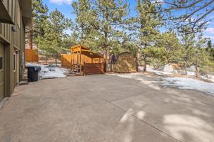 a large driveway with a house and a fence at Bear House - EV #3073 in Estes Park +55 photos