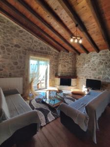 a room with two beds in a stone building at Drymaia Chalet in Amfikleia