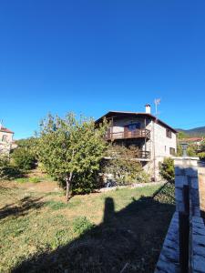 a house sitting on top of a grass field at Drymaia Chalet in Amfikleia